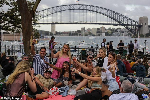 Sydney's New Year's Eve fireworks displays at the Harbor Bridge will deliver a $151 million boost to the city's economy (Photo: New Year's revelers in 2022)