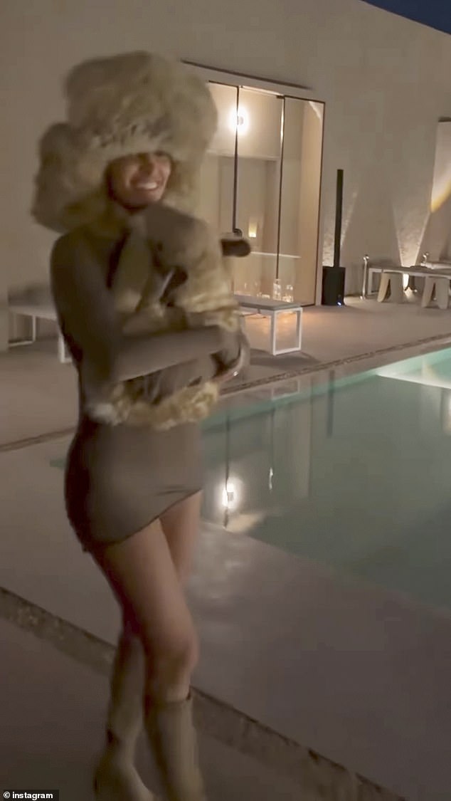 Bianca was seen wearing a gray mini dress, which showed off her toned legs, and a huge faux fur hat that partially covered her face and holding a stuffed animal.