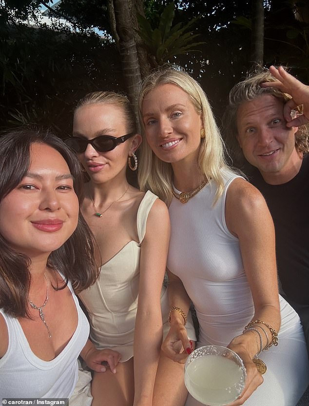 Holtznagel (second from left) wowed guests in a beige bustier and wore a matching miniskirt.  Pictured with Caroline Tran and Bernadette Fahey