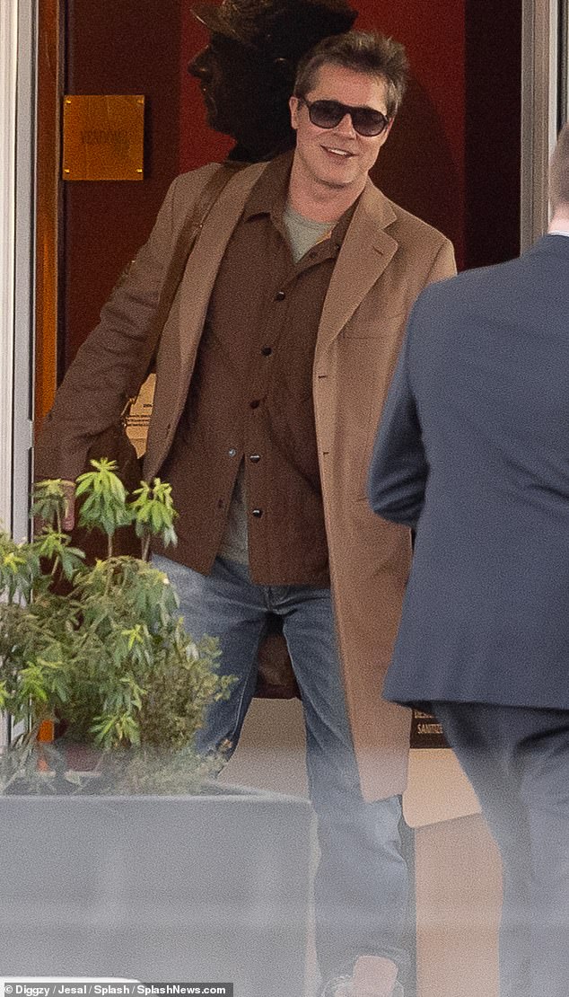 As he left the hotel, Brad looked stylish in a brown shirt and blue jeans, which he teamed with beige trainers and a smart jacket.