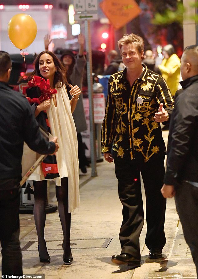 Brad Pitt celebrated his 60th birthday in a striking, glittering suit on Tuesday as he stepped out for a party in LA with girlfriend Ines de Ramon, 33, by his side.