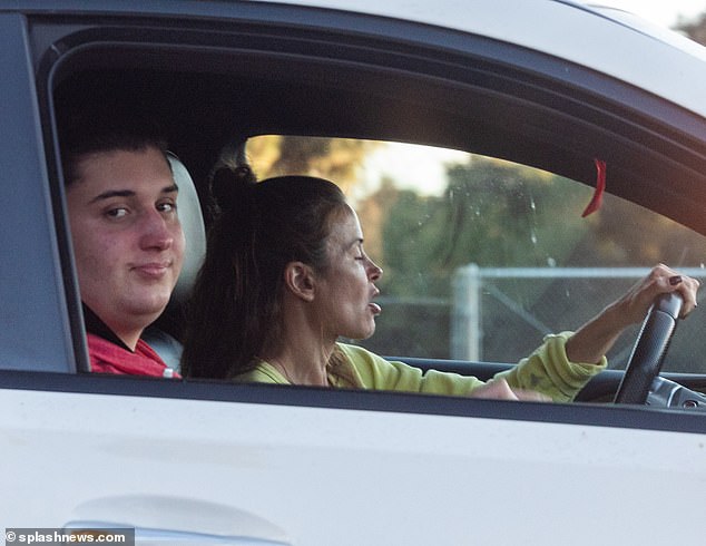 Khuri was also seen sitting in the passenger seat of a car with his mother, grinning at the camera as he let his mother drive him to get a haircut.