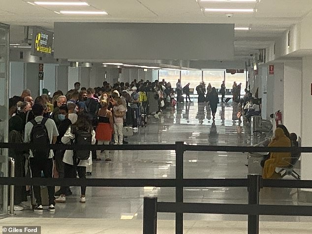 British travelers queue for hours at passport control at a Spanish airport