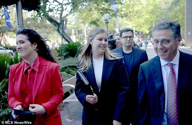 Brittany Higgins is photographed outside court on Tuesday with her best friend Emma Webster (left) and her fiancé David Sharaz (back) and lawyer Leon Zwier (right)