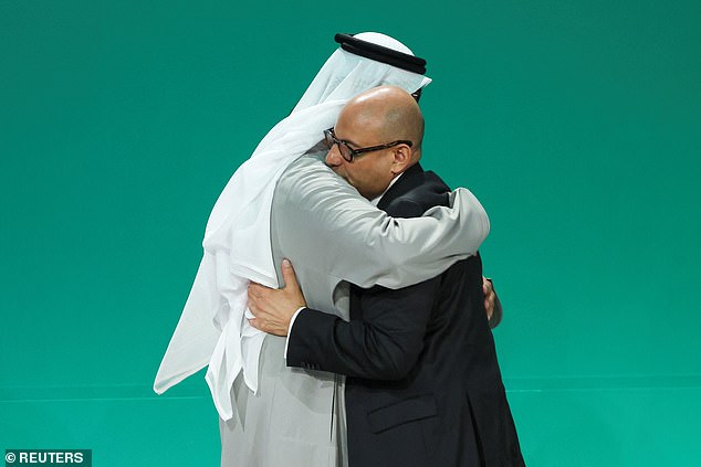 COP28 President Sultan Ahmed Al Jaber hugs UNFCCC Executive Secretary Simon Stiell after a draft negotiating agreement was released