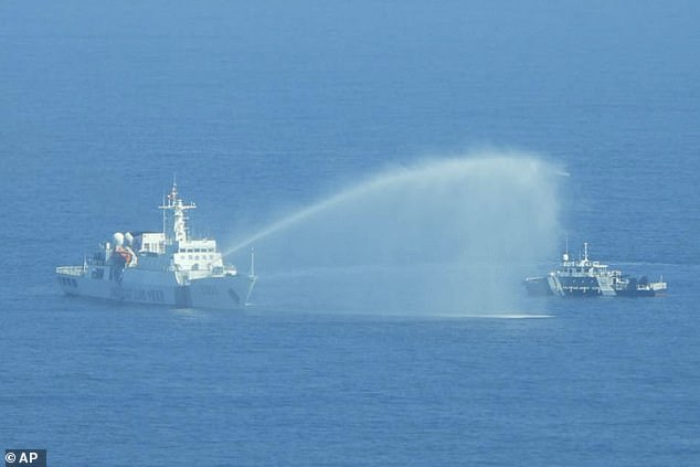 A Chinese coast guard fired water cannons at a Philippine boat near the Beijing-controlled Scarborough Shoal in the latest incident in the South China Sea.