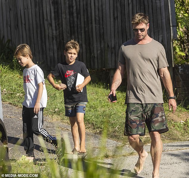 The Australian superstar was flanked by his two sons, Tristan and Sasha, as he went for a barefoot walk in the NSW coastal town where he lives with his family.