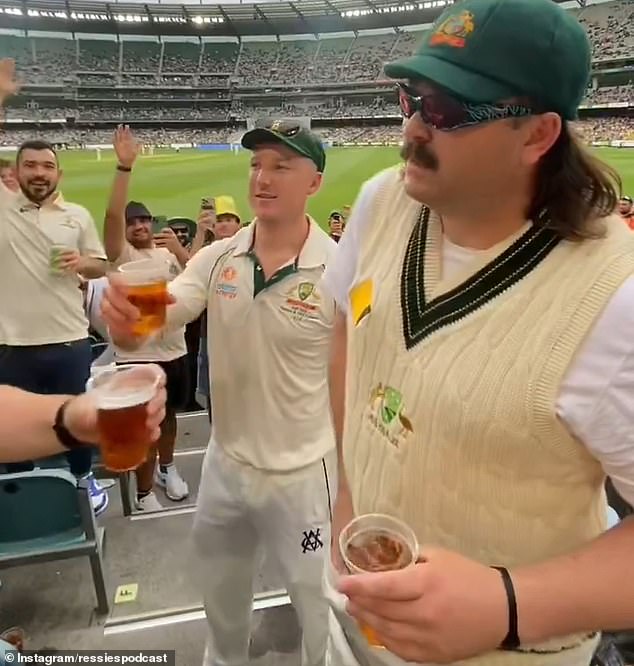 Comedian Checkers (right) pulled his protective box out of his pants and drank beer from it at the MCG on Boxing Day