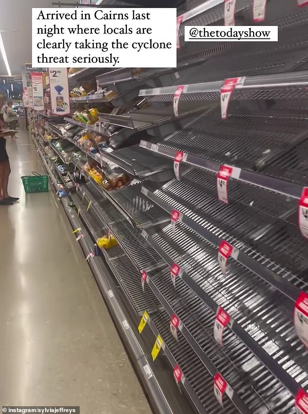 Cairns supermarket shelves have been cleared of essentials such as bottled water and canned goods, but some items are still available (pictured)