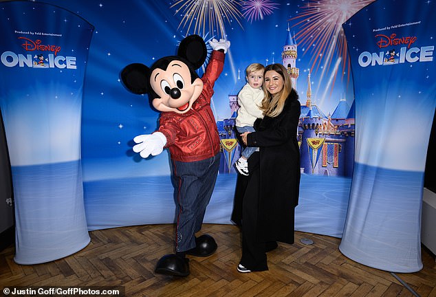 Dani Dyer, 27, cuddled her son Santiago, two, as the pair posed next to Mickey Mouse at this week's Disney On Ice event