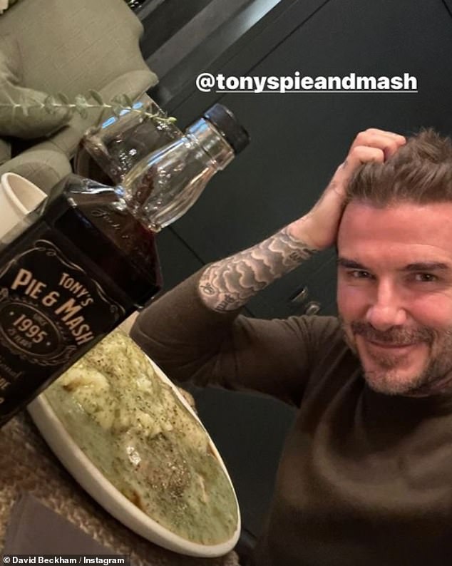 David Beckham, 48, looked happy as he was fed a plate of pie and mash topped with a ladleful of liquor sauce on Thursday