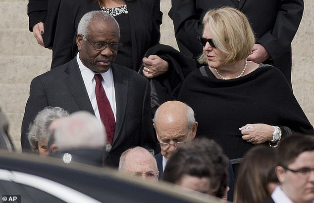 Supreme Court Associate Justice Clarence Thomas, left, and his wife Virginia Thomas, right, after Justice Antonin Scalia's funeral in 2016