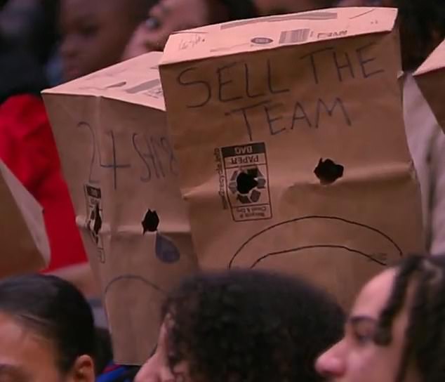 Fan wore paper bags over their heads with the message 'sell the team' in large letters