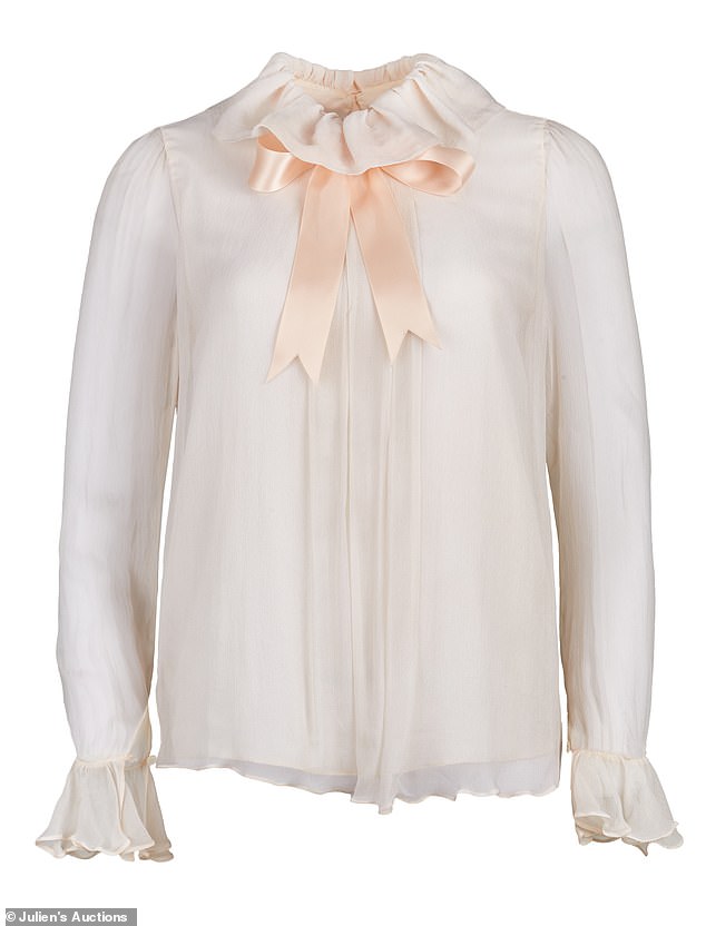 This blouse by Elizabeth Emanuel was worn by Diana in her engagement portrait by Lord Snowdon.  It will be auctioned later this month and is expected to fetch almost £80,000
