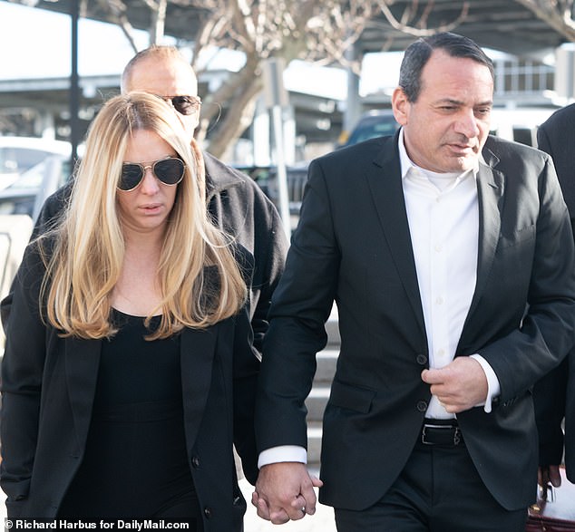 Dr.  Francis Martinis, 55, a Long Island urologist, and his wife, Jessica, arrive at the Suffolk County Criminal Court on Thursday