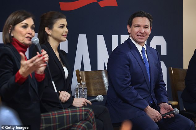 Ron DeSantis, flanked by wife Casey (center) and Iowa Governor Kim Reynolds (left), still trying to close the gap on Trump with just 27 days until Iowa