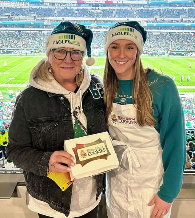 Donna Kelce poses with daughter-in-law Kyle after her homemade cookies were sold for an autism charity during the Philadelphia Eagles game on Christmas Day