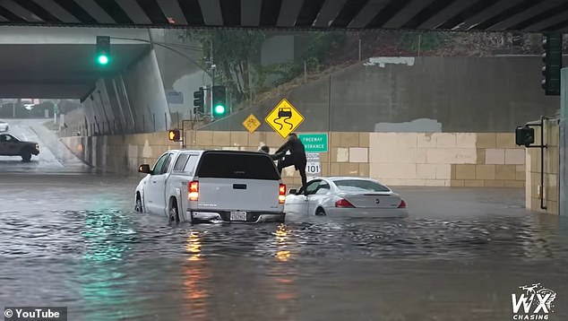 A Good Samaritan heroically saved a child and his father from their car just before it drifted away during the flash floods in Southern California