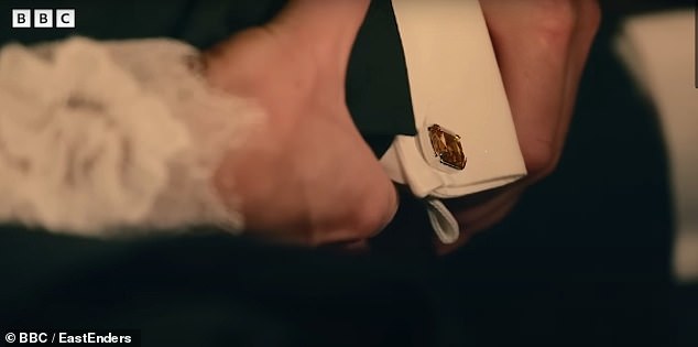 Over the past ten months, fans have been getting small clues pointing to the mystery male character's identity.  A telling sign is that a pair of cufflinks can be seen on the body.