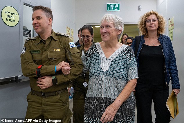 Margalit Moses, 77, escorted by a soldier to a hospital in Israel after her release by Hamas on November 24