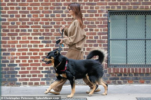 The catwalk veteran stepped out in white sneakers.  She wore hoop earrings and black-rimmed glasses in the morning sun