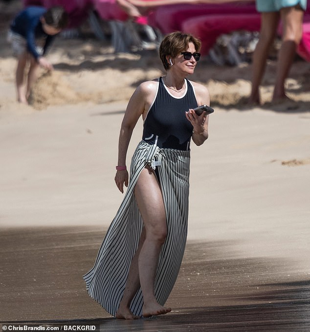 Emma Forbes looked stunning as she walked along the beach in a black swimsuit on Wednesday and enjoyed a lavish holiday in Barbados