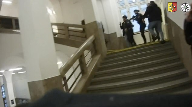 The brave officers, armed with rifles and body armor, sprint up the stairs and raise their weapons - knowing they could face the gunman at any moment.