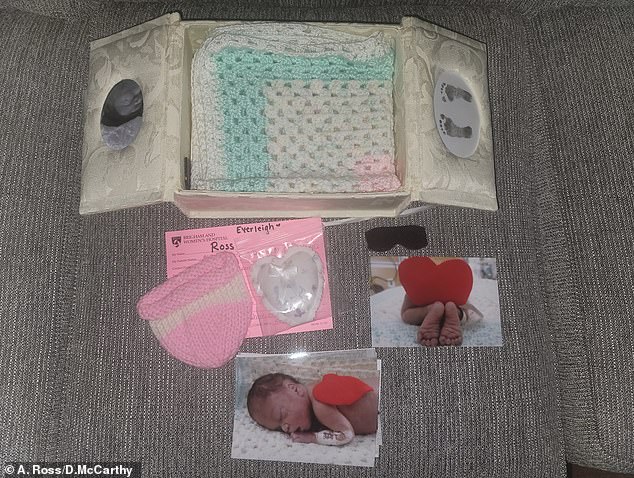 A memory box that the grieving parents made containing photos of baby Everleigh, her footprints, a knitted hat, baby blanket and other treasured items