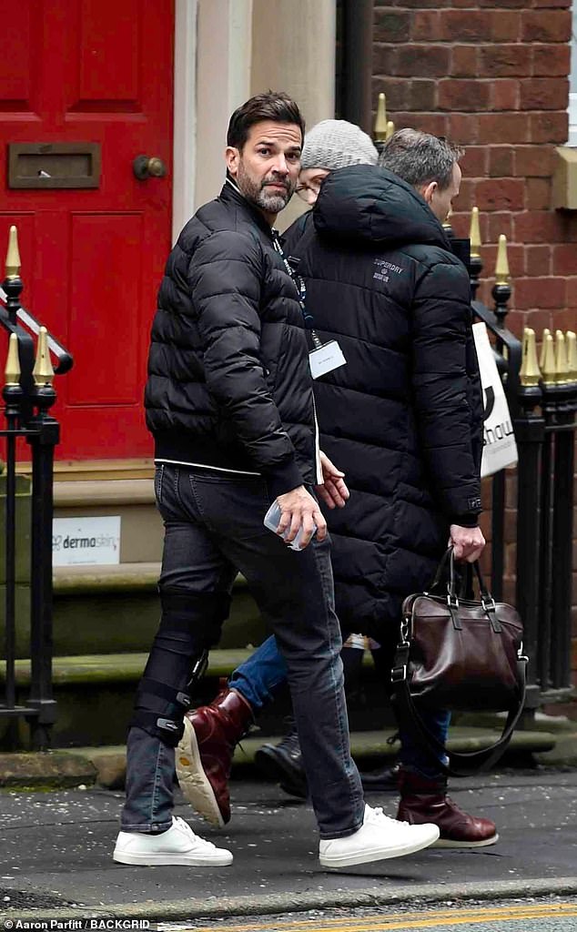 Gethin Jones, 45, was seen limping around Manchester on Tuesday while wearing a knee brace after reconstructive surgery