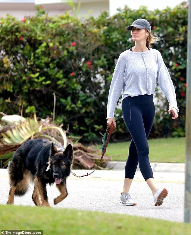 Gisele Bündchen, 43, looked slim and fit on Friday as she took her huge German Shepherd for a walk in Miami