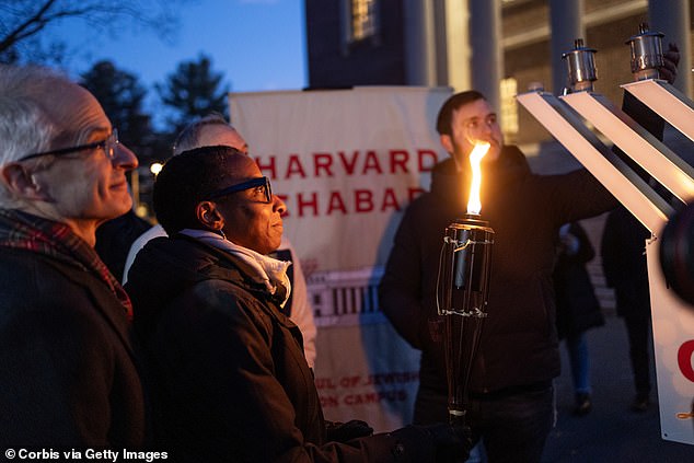 Harvard President Claudine Gay is seen lighting the menorah on campus Wednesday evening