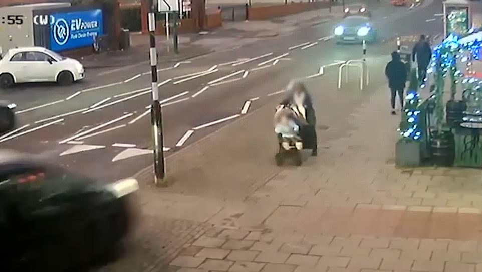 Video shows the mother pushing her child in a stroller as the car veers off the side of the road