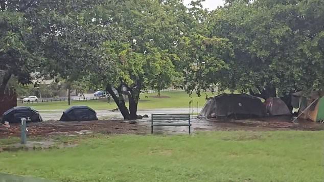 Heartbreaking footage has captured the 'sad reality' of people sleeping rough after tents in a park in Brisbane's CBD were swamped by wild storms