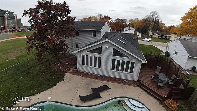 The house is flanked by a similar community center on one side and Lambeau Field on the other