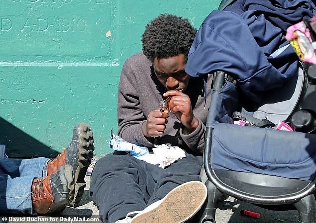 Above is a man on the streets of San Francisco using drugs