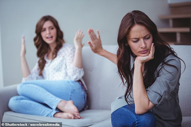 Two girlfriends sit on the couch and argue with each other (stock image)