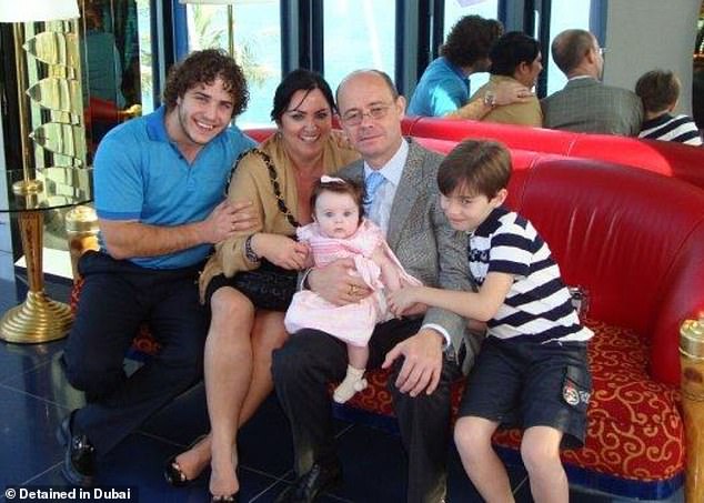 Mr Douglas with his son Wolfgang (left) and his two grandchildren.  He was arrested in September 2019, after a court found him liable for his son's debts and imposed a three-year prison sentence