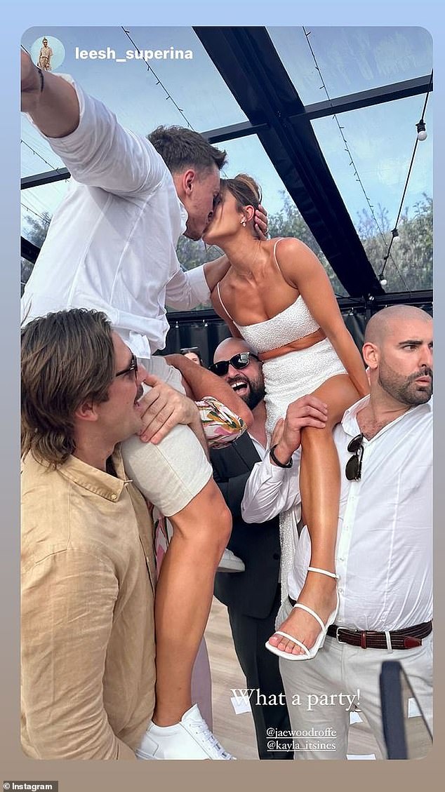 Kayla Itsines married her fiancé Jae Woodroffe this weekend.  And the influencer has shared some candid photos of the wild reception, including one showing the newlyweds balancing precariously on the shoulders of several friends as they share a passionate kiss.  Both shown