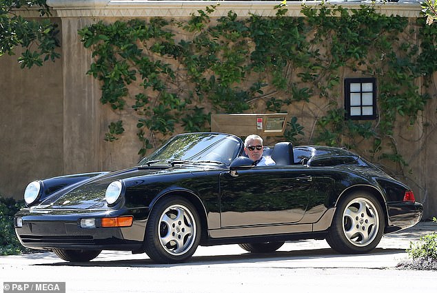 The results also identified that people with higher status are perceived as more competent and preferred in choosing a job.  Pictured is George Clooney, 61, driving a classic Corvette in 2020