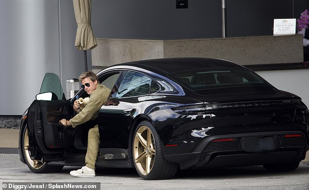 Men who own luxury cars such as Corvettes and Porsches are perceived to have higher levels of mating values ​​and social dominance and are viewed as more competent.  Pictured: Brad Pitt, 59, driving a $200,000 electric Porsche Taycan