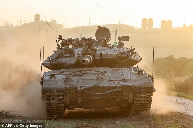 An Israeli military tank rolls near the border with the Gaza Strip on December 3, 2023
