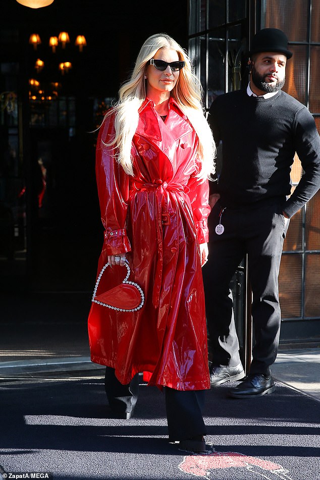 Jessica Simpson looked stunning in a shiny red trench coat as she left her hotel in Manhattan