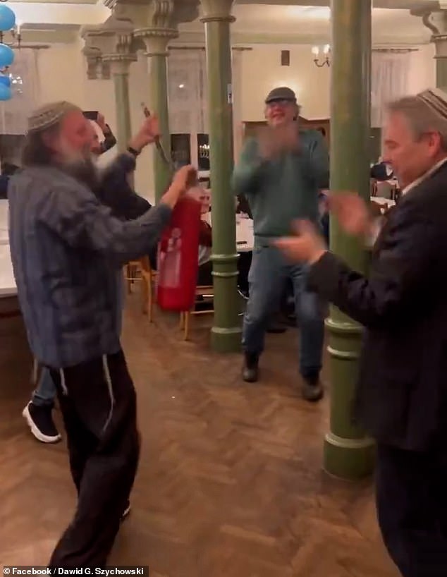 In a video clip shared on social media, a group of Jewish men are seen cheerfully holding up a fire extinguisher and passing it to each other as they dance