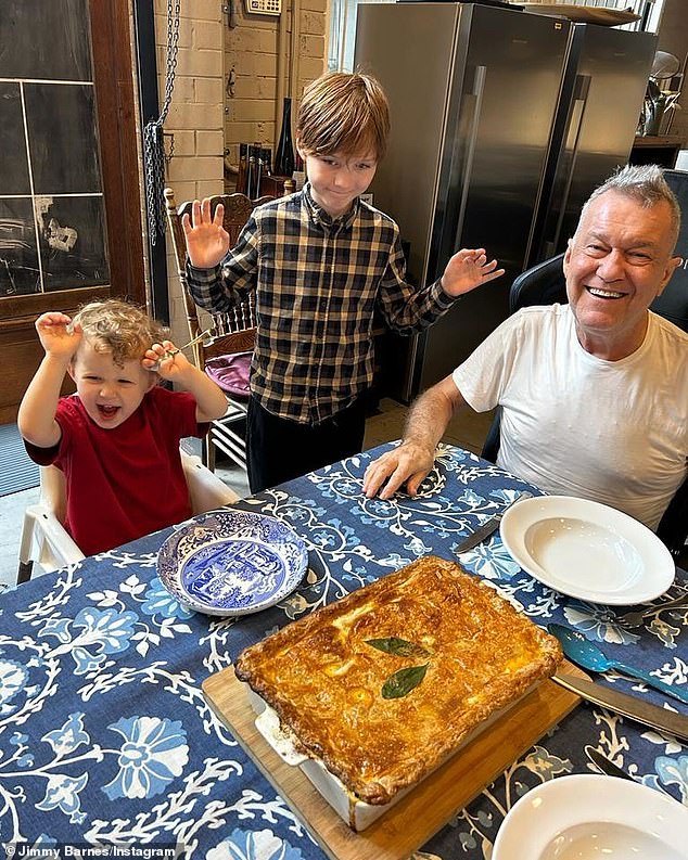 Jimmy Barnes has plenty to celebrate this holiday season.  The Working Class Man hitmaker took to Instagram on Boxing Day to share his latest health update with his adoring followers, alongside two images.  The first photo shows Jimmy smiling from ear to ear with two of his grandchildren in front of a freshly baked cake