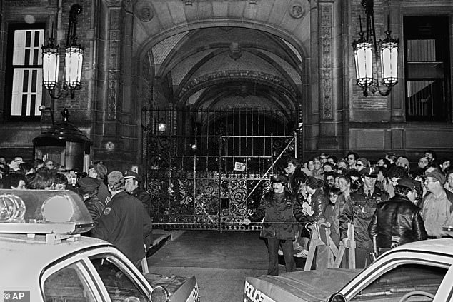 A crowd gathered outside the Dakota apartment complex (pictured) after Lennon, who lived there, was shot in front of the building hours earlier