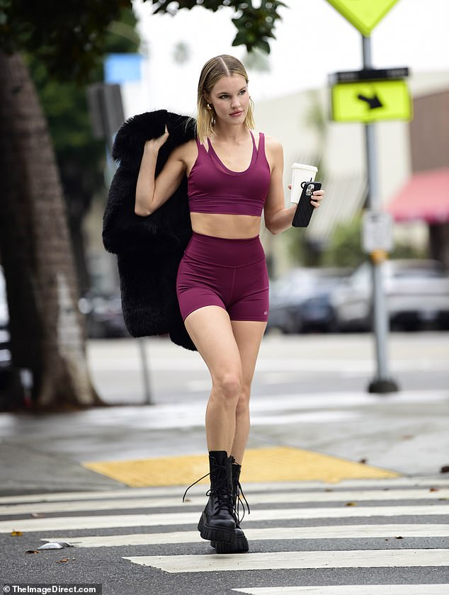 The model, who recently admitted to lying about her age, wore a sleeveless burgundy athletic top that exposed her sculpted arms and part of her washboard abs.