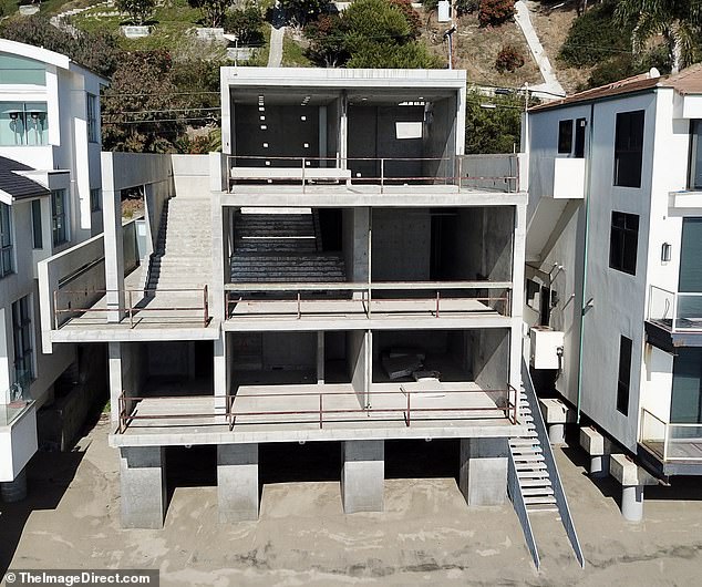 Kanye West has put his Malibu home up for sale for $53 million after failing to convert it into a 'fallout shelter' without windows or electricity;  the windowless house pictured in December