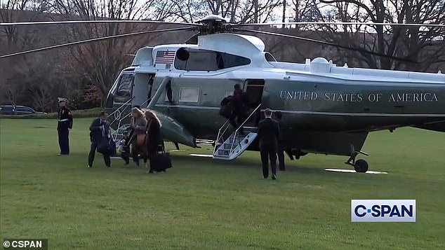 Hunter Biden leaves Marine One Tuesday morning as his son Beau Biden (in foreground) is escorted by White House aides