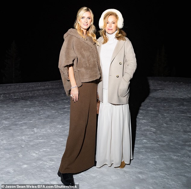 The Real Housewives of Beverly Hills star, 64, looked stunning in a camel-colored wool coat with sweater sleeves.  She was covered from top to bottom in a snow white turtleneck and a white layered maxi skirt, with some furry earmuffs for style and comfort