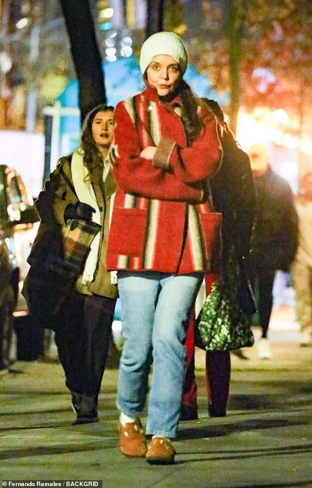 Katie Holmes wore a cozy-looking textured red coat with white and black stripes as she stepped out into New York City on Friday